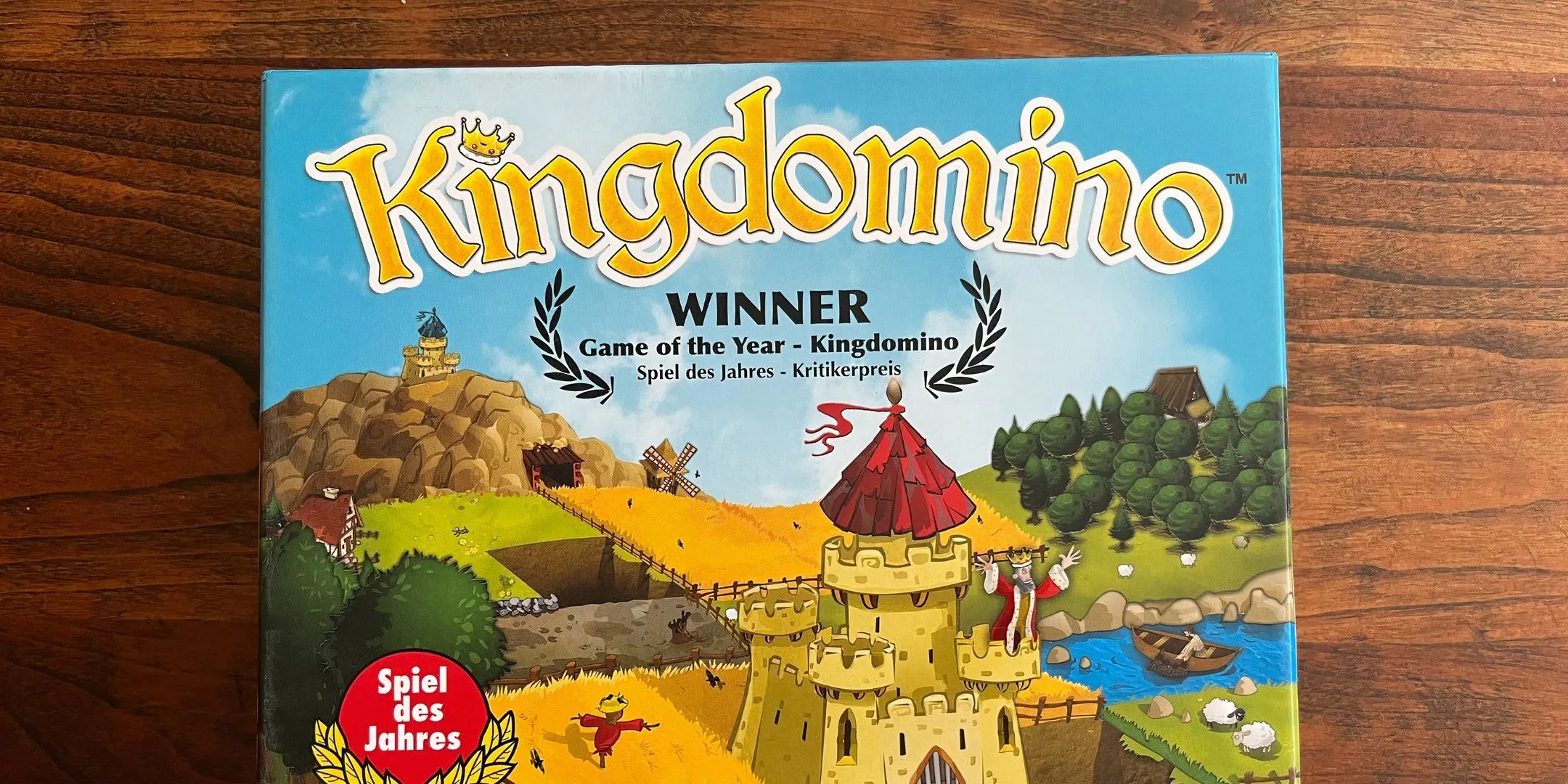 Bìa hộp game King Domino với hình ảnh lâu đài và vương quốc được xây dựng từ các mảnh ghép domino