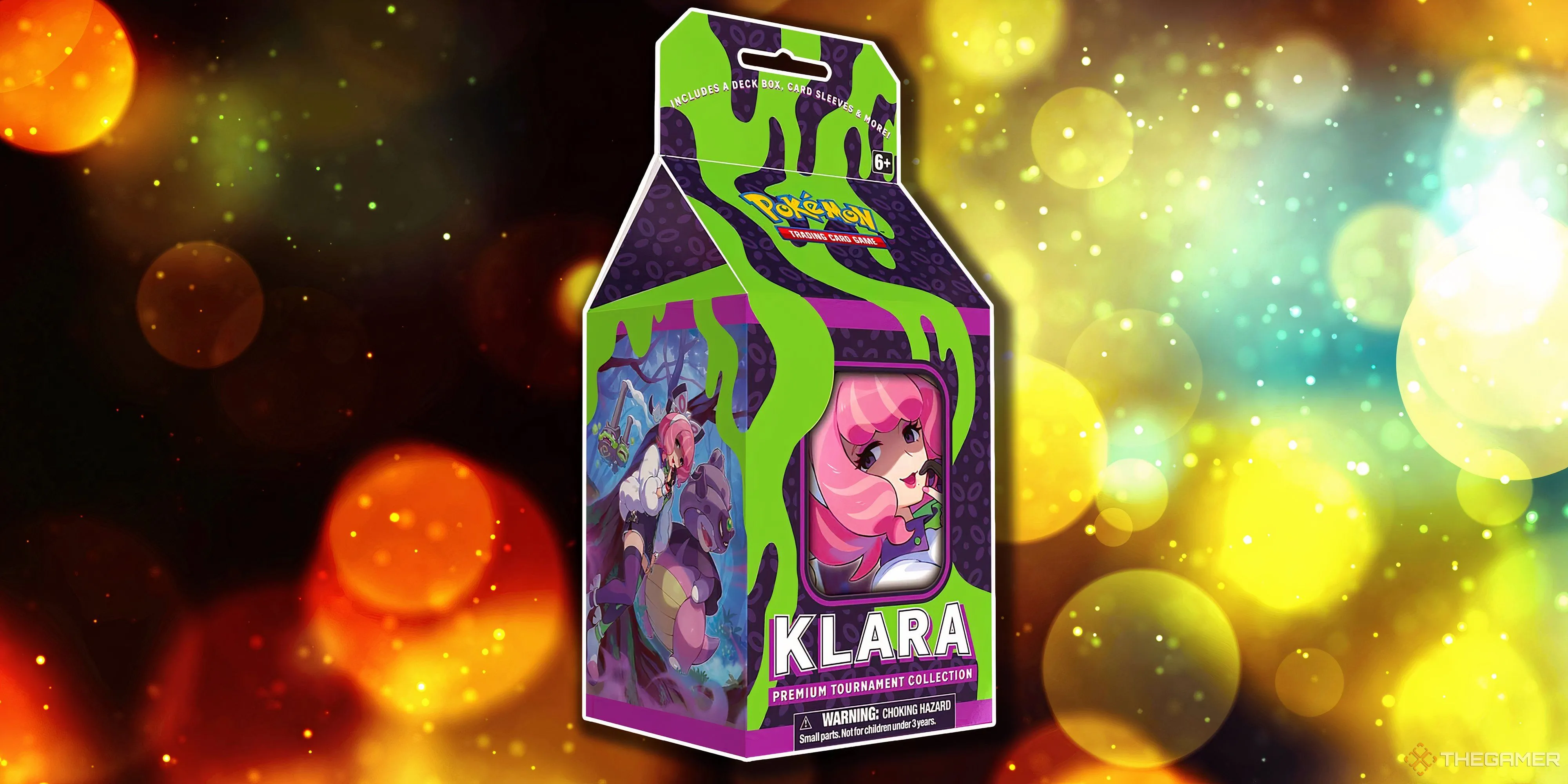 Hộp Premium Tournament Collection Klara nổi bật với sắc hồng rực rỡ, kèm theo các promo card đặc trưng của nhân vật này trong Pokémon TCG.